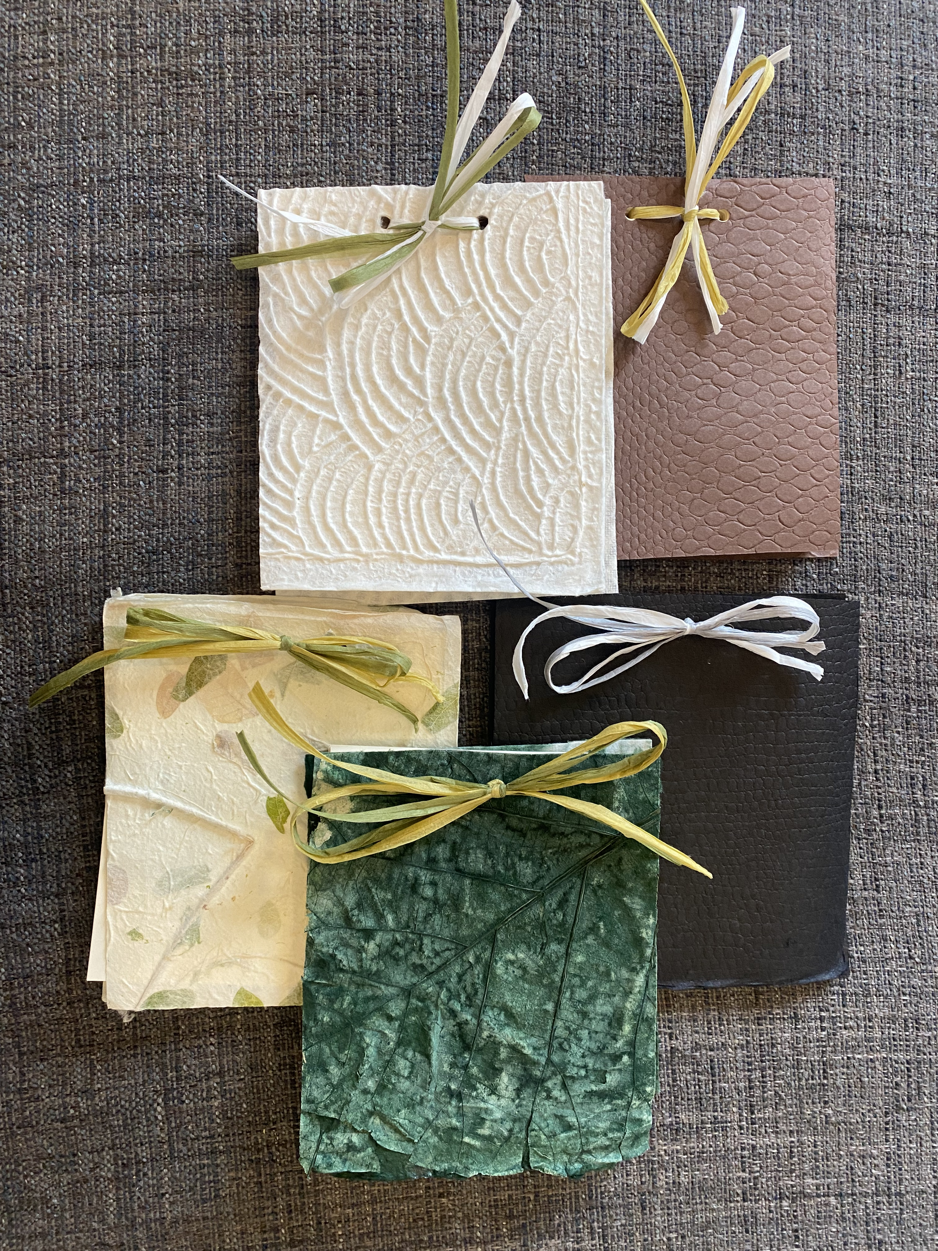 Handmade copies of When I Loved Myself Enough, bound with natural paper and ribbon